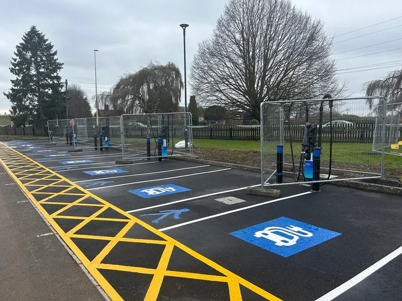 New EV charging bays marked out with charge points installed on fresh tarmac