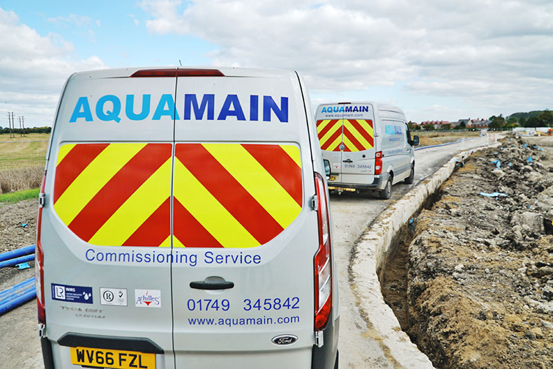 Aquamain vans on a building site