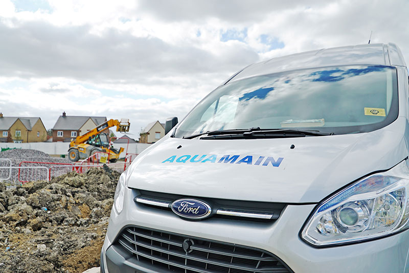 Aquamain van on a building site to carry out pipe installations and water services
